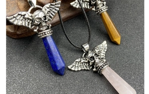 Detail of vintage punk skull wing pendants with lapis lazuli and tiger eye stone
