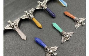 Macro view of retro skull wing pendants with colorful hexagonal crystal prisms