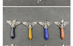 Detail of gothic punk skull pendants with hexagonal crystal stones in varied colors