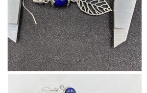 Detailed view of silver leaf earrings with lapis lazuli beads and caliper measurement