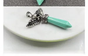 Gothic punk skull wings pendant with turquoise hexagonal prism stone detail