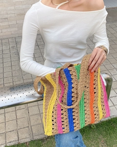 Detail of colorful striped hand-crocheted tote bag with high-saturated knit texture