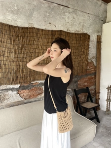 Detail of hand-woven hollow mesh crossbody bag with shoulder strap in a retro setting