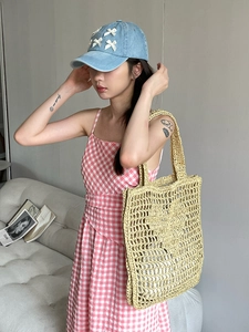 Vue détaillée du sac cabas en paille avec casquette en jean et robe à carreaux