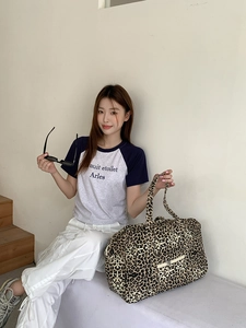 Chic leopard print canvas tote bag with large capacity and sturdy handles for travel