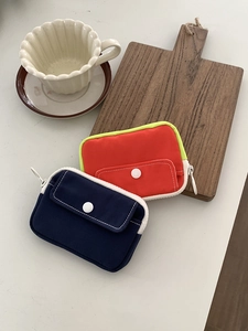 Mini canvas coin purse in blue and orange colors with front snap pocket for cards