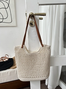 Detail of hand-woven crochet summer tote bag with durable brown faux leather straps