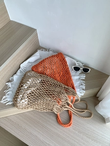 Detail of large woven cotton shoulder bags with mesh design and white inner lining