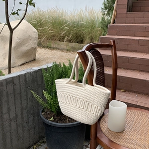 Handmade cream woven cotton rope tote bag with wavy patterns for beach vacation and casual use