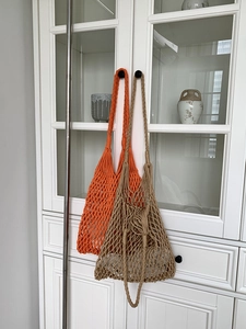 Handmade crochet mesh shoulder bag for summer beach travel in orange and khaki colors