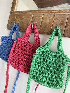 Handwoven hollow cotton shoulder bags in blue, pink, and green colors with crossbody straps