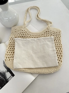Detail of hollow crochet tote bag with removable canvas drawstring inner pouch