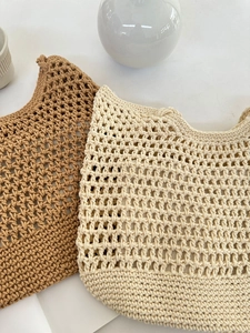 Detail of handmade crochet hollow mesh bags in khaki and cream white cotton rope