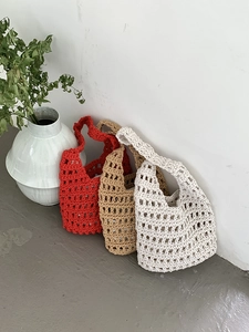 Detail of hollow knit cotton rope shoulder bags in red, khaki and cream white