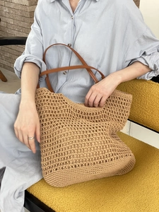 Handmade woven hollow straw tote bag with brown leather handles for summer casual style