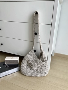 Detail showing the intricate crochet weave and texture of this beige cotton tote bag