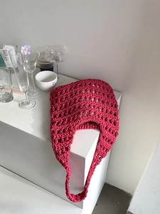 Detail of hand-woven magenta hollow knit tote bag showing intricate cotton rope texture