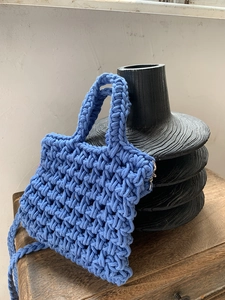 Blue hand-woven cotton small tote bag with intricate knit texture and top zipper closure
