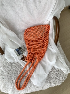 Handmade orange cotton mesh string bag for summer beach holidays and daily shopping