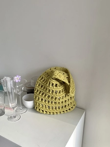 Detailed close-up of lime green hand-woven cotton rope tote with hollow mesh texture