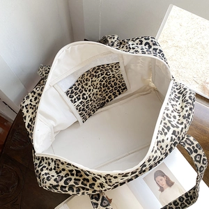 Detailed interior view of leopard print canvas tote bag with functional inner pocket