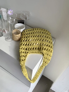 Close-up of ginger yellow crochet cotton tote showing intricate hollow woven texture