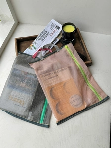 Close-up of translucent mesh storage bags with zipper and handle for A4 documents