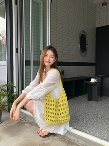 Detailed view of yellow hollow cotton rope hand-woven hobo shoulder bag for summer