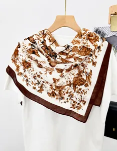 Close-up of vintage butterfly print silk square scarf hanging on a wooden hanger