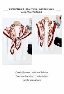 Detail of vintage butterfly and floral print silk scarf styled on a white T-shirt