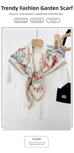Detailed embroidery on floral cotton linen scarf with garden prints on off-white fabric