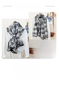 Detail of a lightweight black and white rose pattern scarf with striped accents