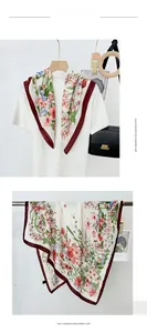 Detailed view of floral silk scarf with pink and red flowers on white imitation cashmere