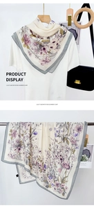 Detail view of floral print imitation cashmere scarf with elegant lilac pattern and grey border