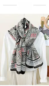 Detail of geometric pattern printed scarf styled on white shirt with wooden hanger