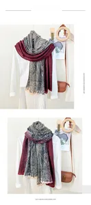 Detail of imitation cashmere scarf with burgundy paisley pattern in a layered styling