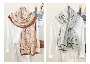 Detail of geometric pattern scarf in caramel and grey colors with breathable texture