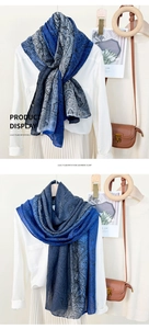 Detail view of cashew paisley print scarf showing soft texture and elegant styling