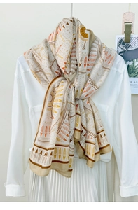 Detail of bohemian geometric print scarf with ethnic feather patterns on cream fabric