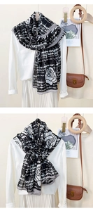 Detail of classic black and white plaid scarf with elegant rose floral print on a shirt