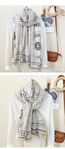 Detail of a lightweight scarf with geometric and feather prints styled on a shirt