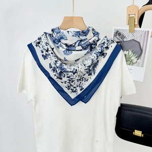 Vintage 90x90 blue butterfly print square scarf draped on white tee with leather bag