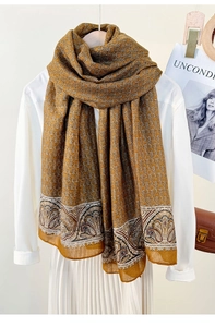 Detail of vintage long scarf with chain and paisley patterns over a white shirt