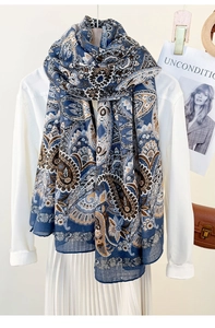 Detail shot of navy blue paisley pattern scarf styled with a white shirt and skirt