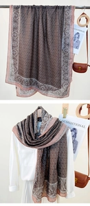 Close-up of lightweight paisley chain print scarf in brown and pink silk-like fabric