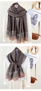 Detail shot of vintage chain and paisley print scarf in elegant brown and coffee tones