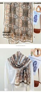 Detailed view of paisley imitation cashmere scarf with elegant brown and beige patterns