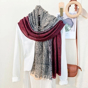 Elegant paisley print scarf in burgundy and grey, styled for spring and summer beach wear