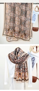 Detail of vintage paisley long scarf layered over a white shirt with autumn accessories