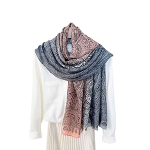 Long paisley print scarf in gradient grey and pink, worn as a lightweight sun shawl